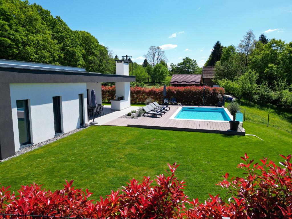 Villa, lawn and private pool on a clear day