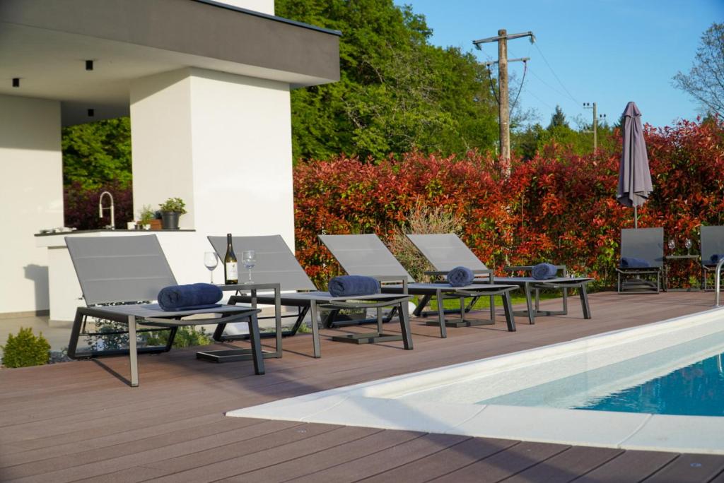 Poolside loungers beside the covered terrace