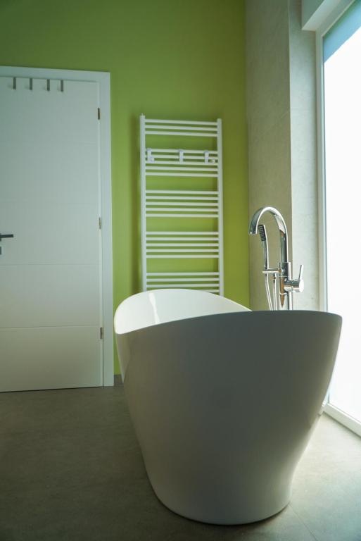 Freestanding bath in the green bathroom