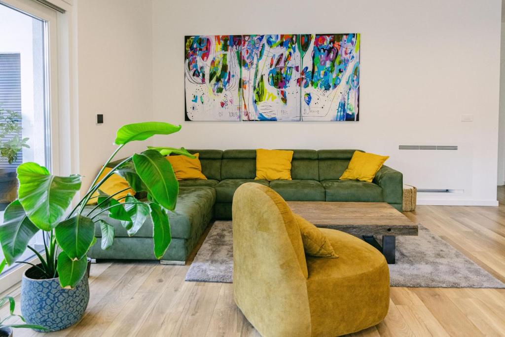 Living room with a green sofa and mustard armchair