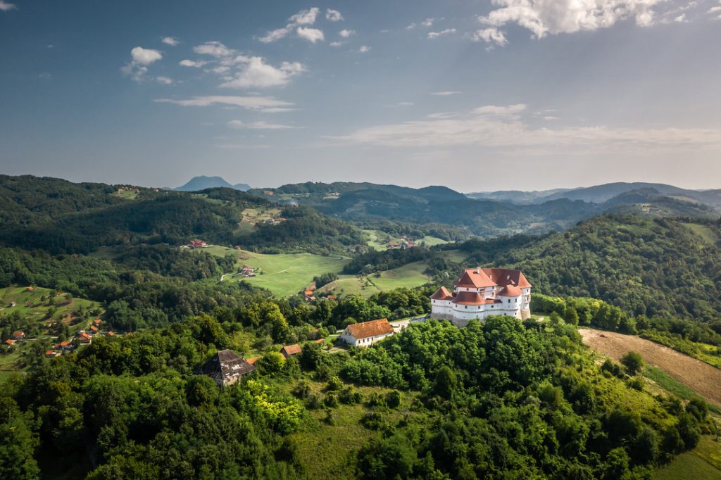 Aerial view of a castle among the green hills of Hrvatsko Zagorje
